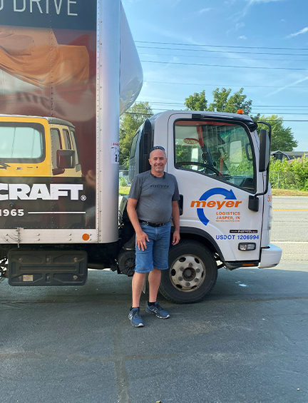 Meyer driver standing in front of a Meyer truck