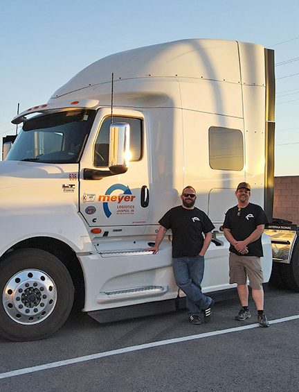 Meyer drivers standing in front of Meyer trucks