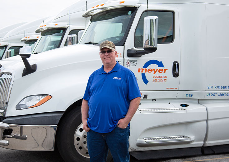 Jerry G. standing in front of a Meyer truck