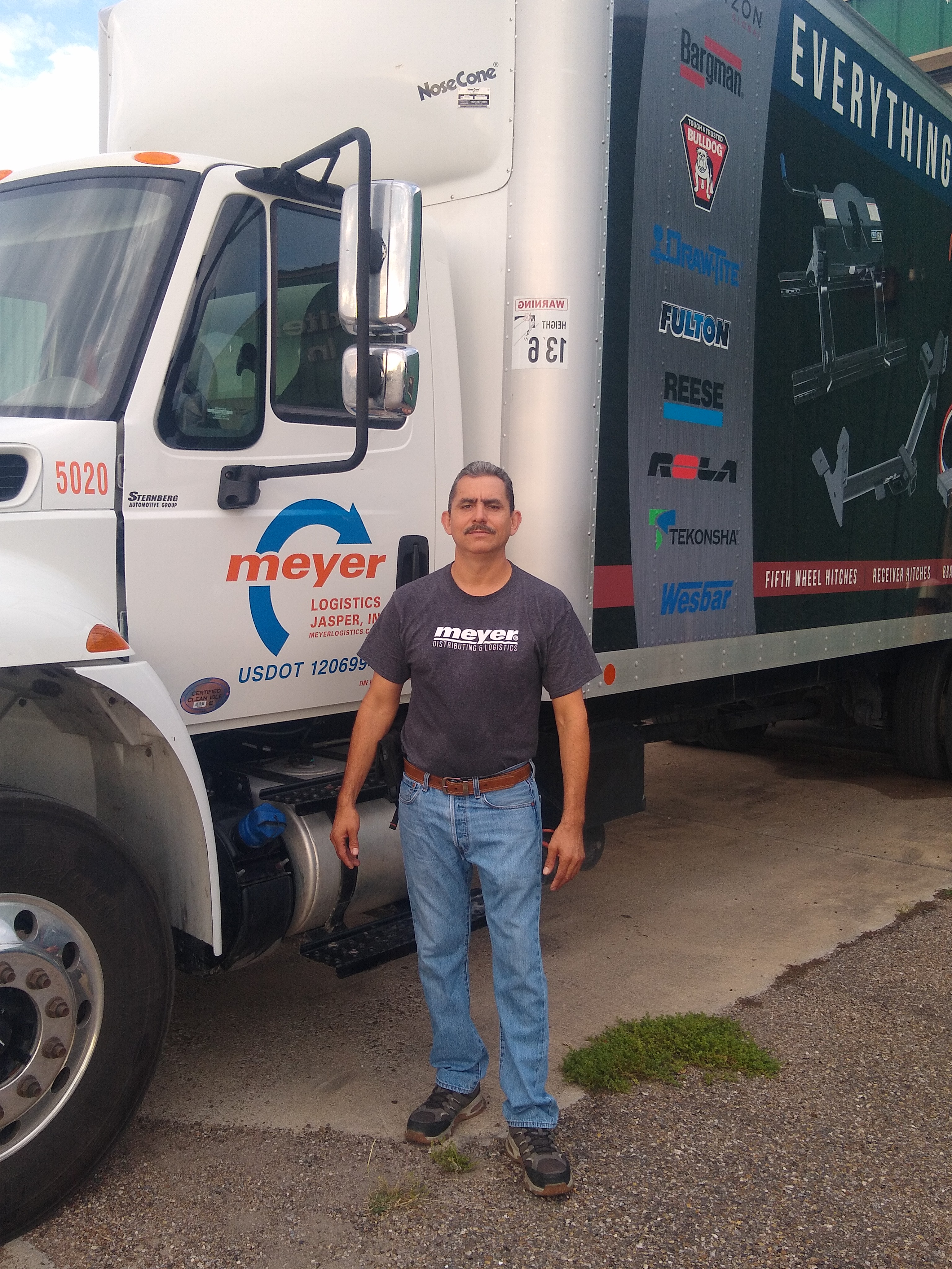 Francisco V. standing in front of a Meyer truck