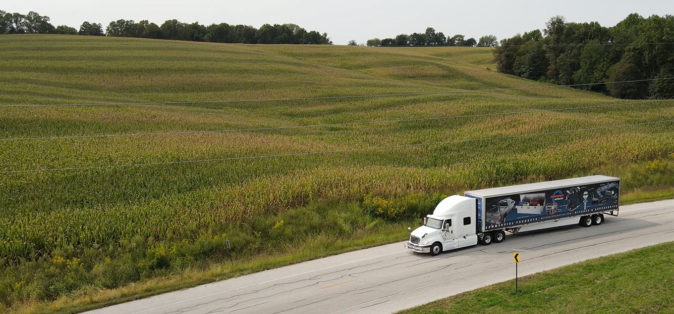 Meyer truck driving by a field
