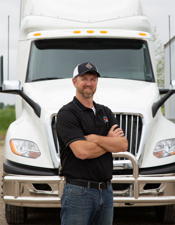 Kenny Fromme standing in front of a Meyer truck