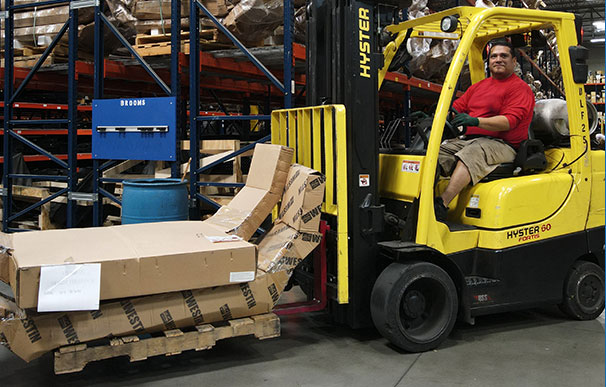 Meyer warehouse employee sitting on a forklift