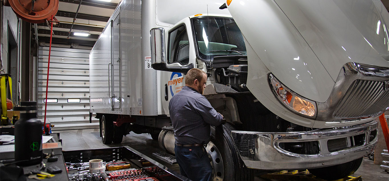 Mechanic working on a Meyer truck